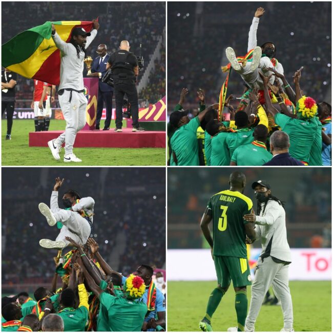 Senegal players raise Cisse 